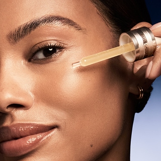 photo of woman using multi-tasking face serum advanced night repair serum