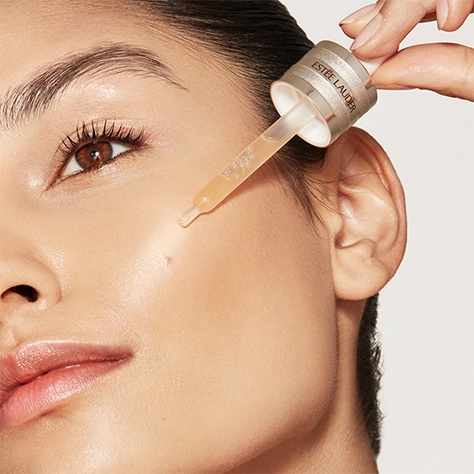 photo of woman applying estee lauder morning skincare routine