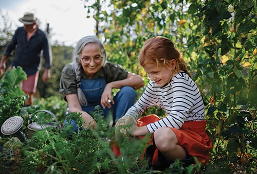 photo of woman and child gardening